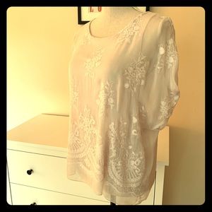 Delicate pink silk blend blouse with lace detail.